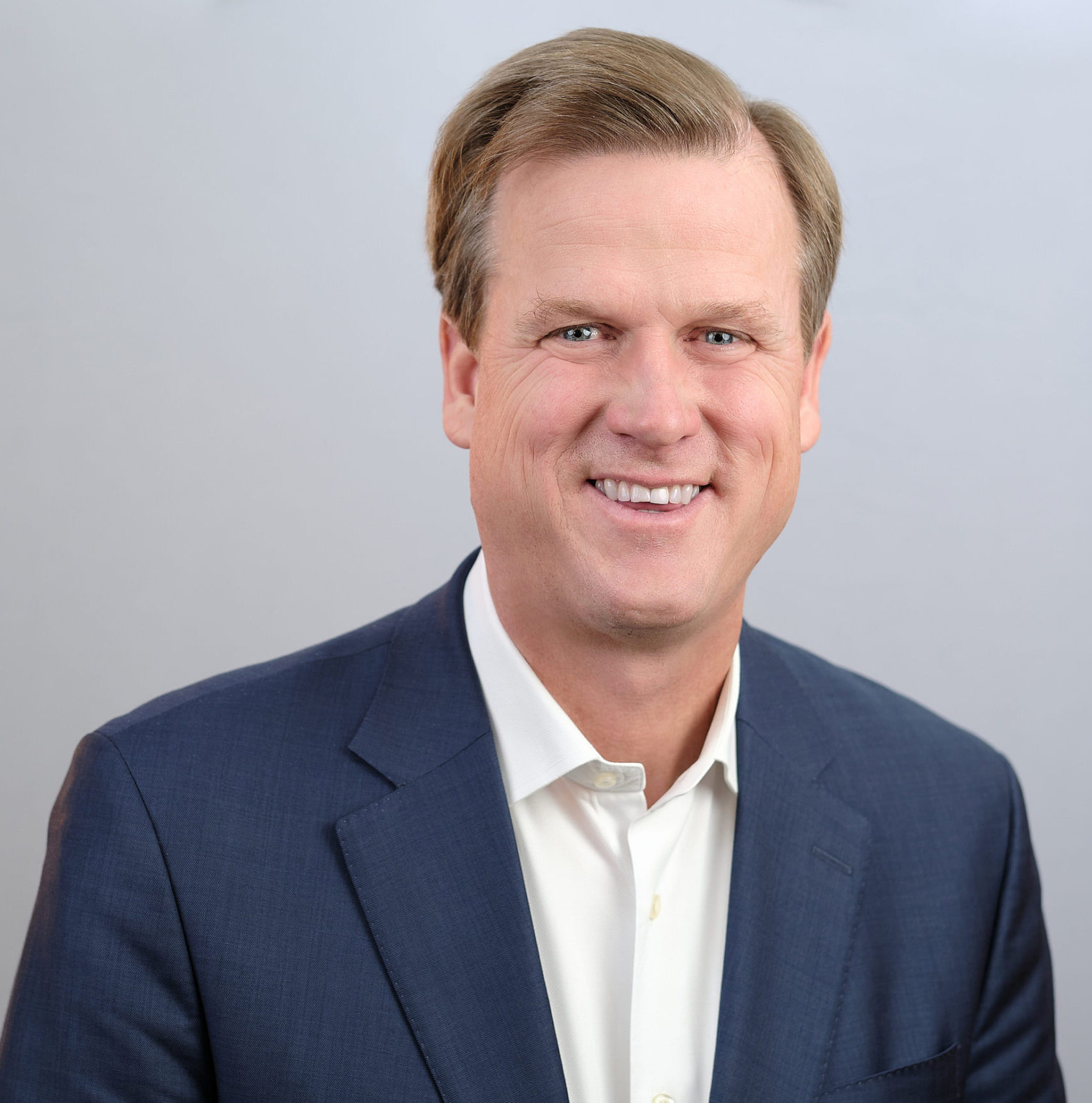 Greg Nelson, CEO of RSA, smiling in a navy blazer